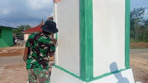 Satgas TMMD Dengan Teliti Cat Sudut-sudut Tugu Prasasti